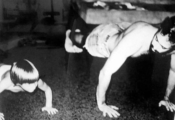 Young Todd Altieri doing push-ups beside his stepfather